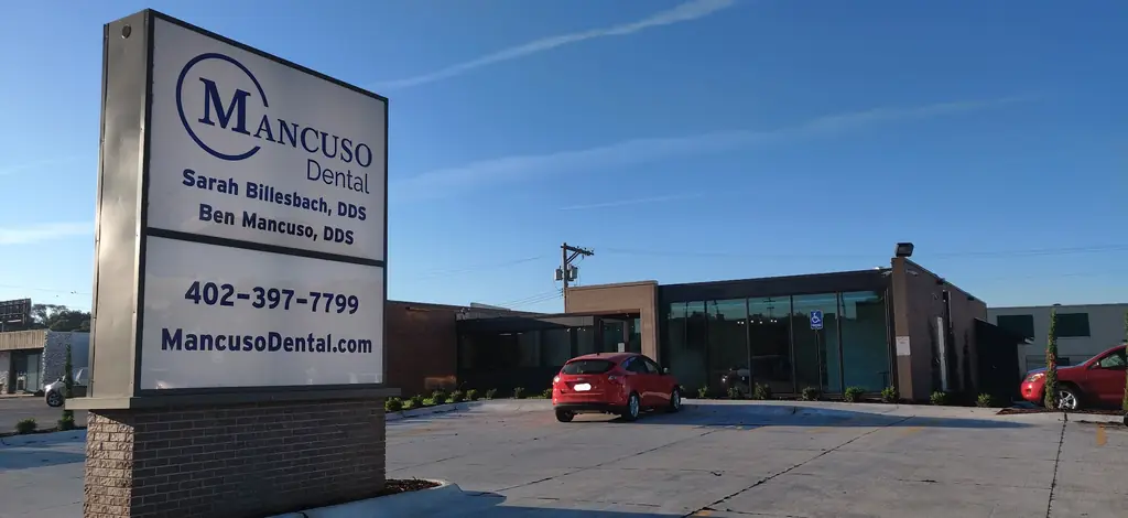 The Mancuso Dental sign on Farnam Street listing both dentists and the phone number